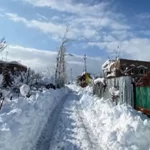 Snow-covered damaged house in Uri Kashmir; Blocked roads in Boniyar after heavy snowfall.